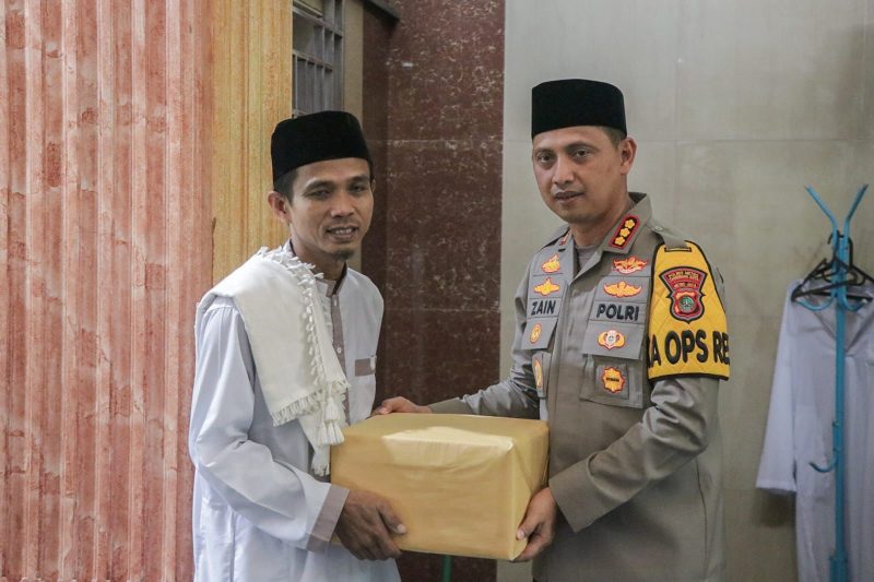 Foto: Kapolres Metro Tangerang Kota Kombes Pol Zain Dwi Nugroho Saat Menyerahkan Cindra Mata ke Warga Usai Sholat Jum'at di Masjid Al - Amin.