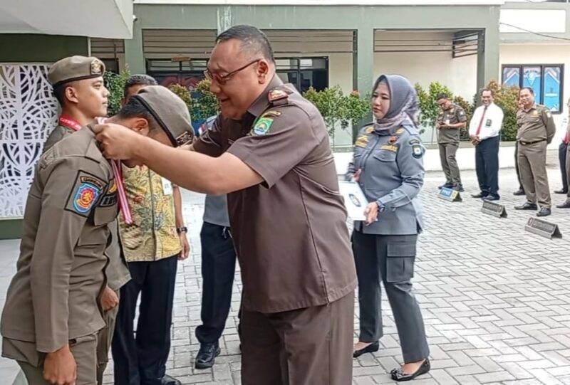 Foto: Manager Sekaligus Staf Satpol PP Kota Tangerang, Otong Kosasih Saat Memberikan Penghargaan Dari Kasatpol PP Kepada Kedua Anggotanya yang Berprestasi.
